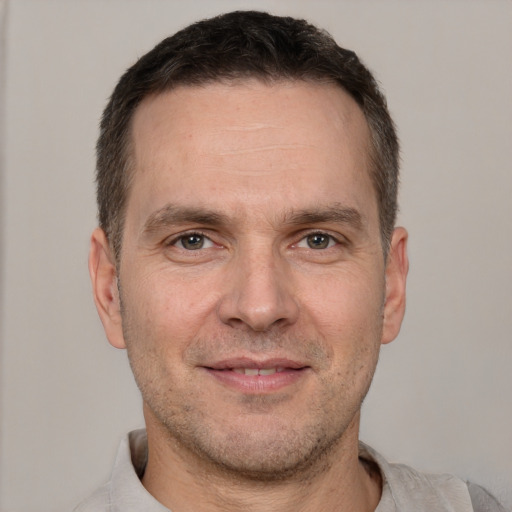 Joyful white adult male with short  brown hair and brown eyes