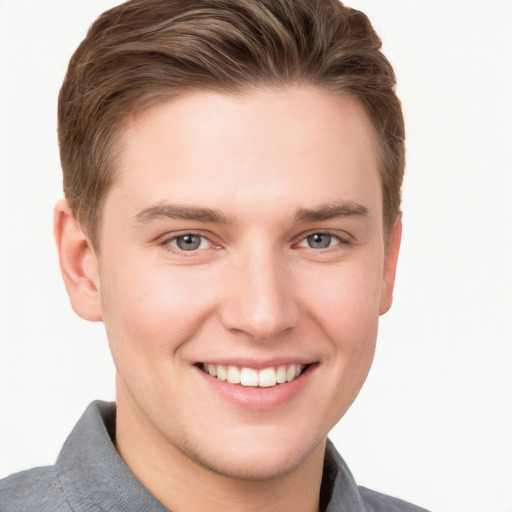 Joyful white young-adult male with short  brown hair and grey eyes