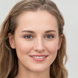 Joyful white young-adult female with long  brown hair and blue eyes