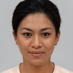 Joyful asian young-adult female with short  brown hair and brown eyes