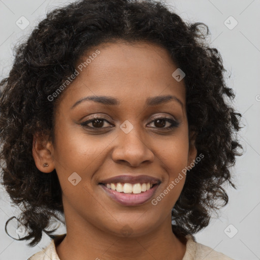 Joyful black young-adult female with long  brown hair and brown eyes