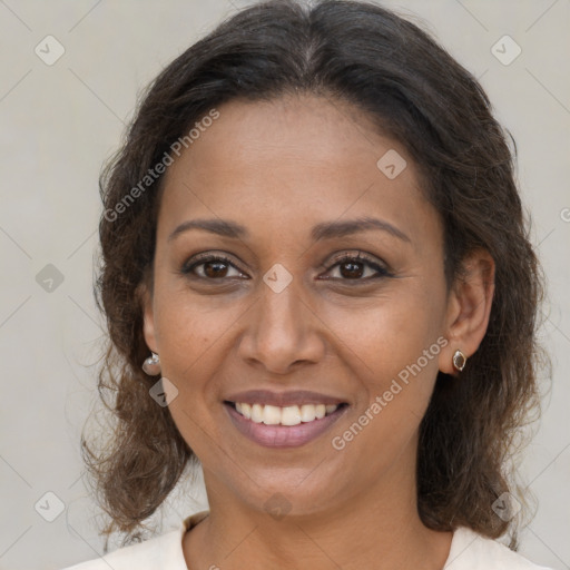 Joyful black adult female with medium  brown hair and brown eyes