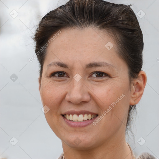 Joyful white adult female with short  brown hair and brown eyes