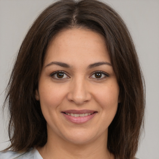 Joyful white young-adult female with medium  brown hair and brown eyes