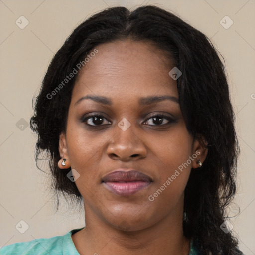 Joyful black young-adult female with long  black hair and brown eyes