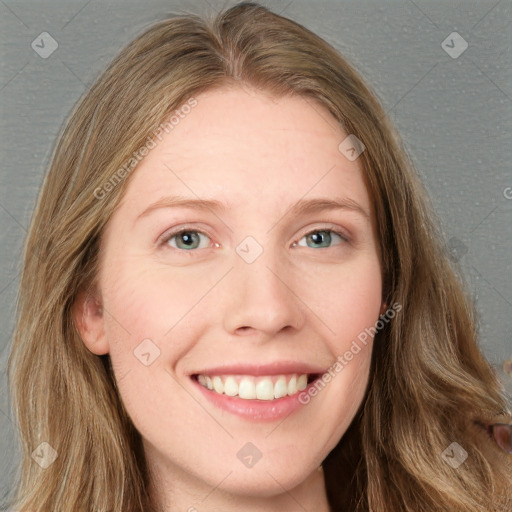 Joyful white young-adult female with long  brown hair and blue eyes