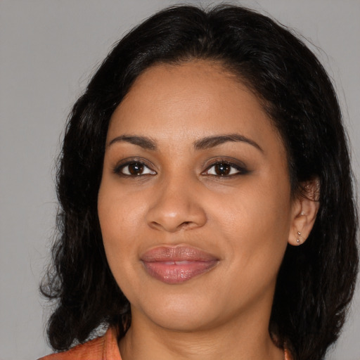 Joyful latino young-adult female with medium  black hair and brown eyes