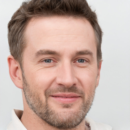 Joyful white adult male with short  brown hair and grey eyes