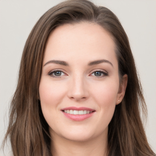 Joyful white young-adult female with long  brown hair and grey eyes