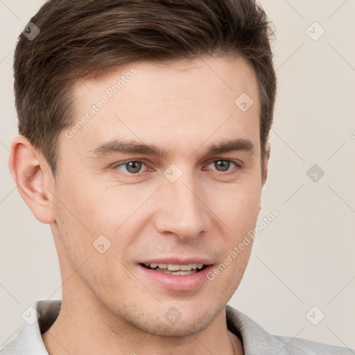 Joyful white young-adult male with short  brown hair and grey eyes