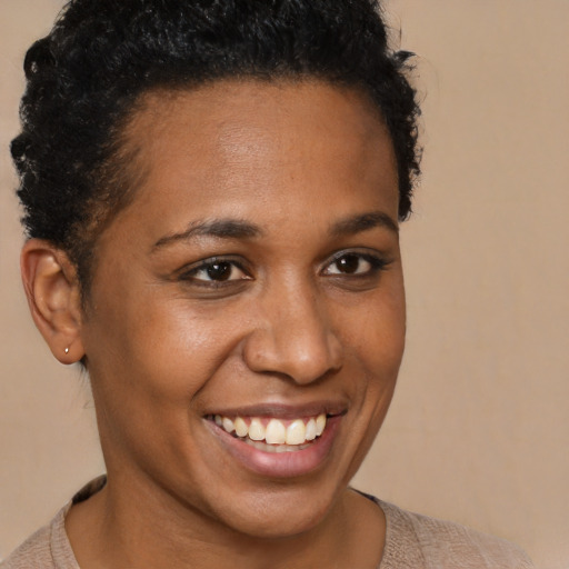 Joyful black young-adult female with short  brown hair and brown eyes