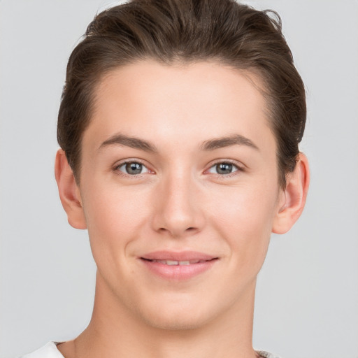 Joyful white young-adult female with short  brown hair and grey eyes