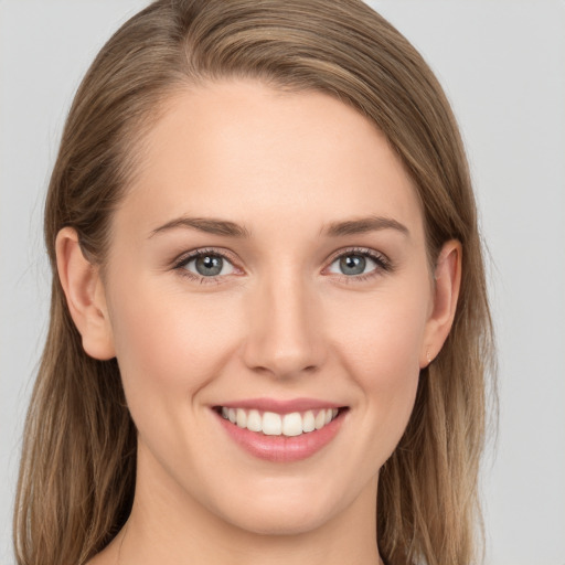 Joyful white young-adult female with long  brown hair and grey eyes