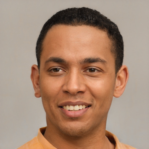 Joyful latino young-adult male with short  black hair and brown eyes