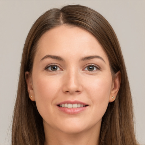 Joyful white young-adult female with long  brown hair and brown eyes