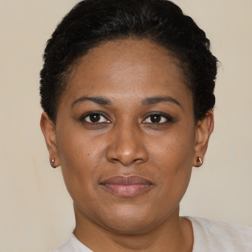 Joyful black young-adult female with short  brown hair and brown eyes