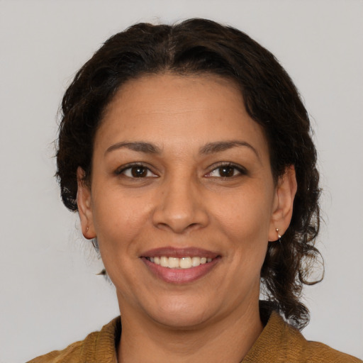Joyful white adult female with medium  brown hair and brown eyes