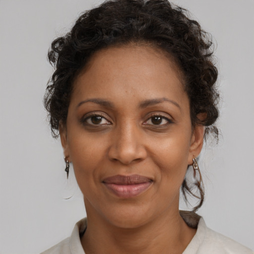Joyful black adult female with medium  brown hair and brown eyes