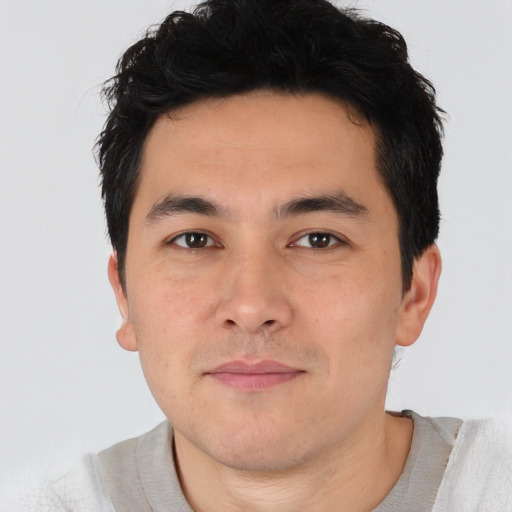 Joyful asian young-adult male with short  brown hair and brown eyes
