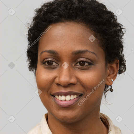 Joyful black young-adult female with short  brown hair and brown eyes