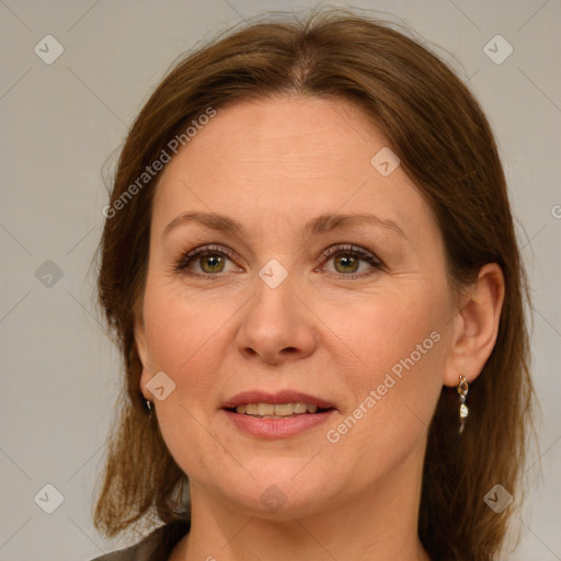 Joyful white adult female with medium  brown hair and green eyes