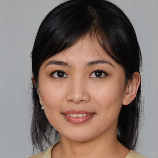 Joyful asian young-adult female with medium  black hair and brown eyes