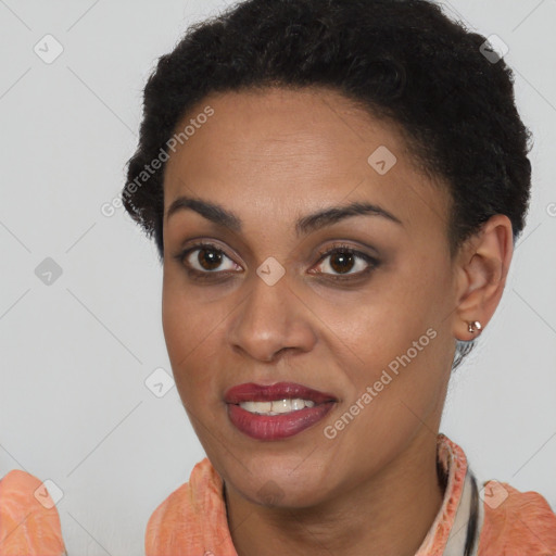 Joyful black young-adult female with short  black hair and brown eyes