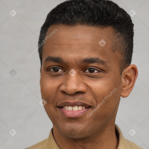 Joyful black young-adult male with short  black hair and brown eyes