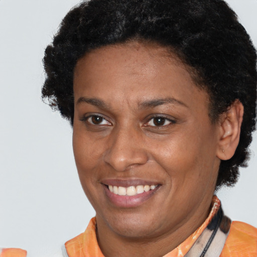 Joyful latino adult female with short  brown hair and brown eyes