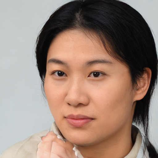 Neutral asian young-adult female with medium  brown hair and brown eyes