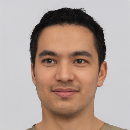 Joyful latino young-adult male with short  black hair and brown eyes