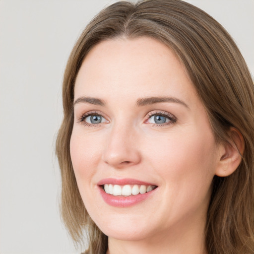 Joyful white young-adult female with long  brown hair and grey eyes