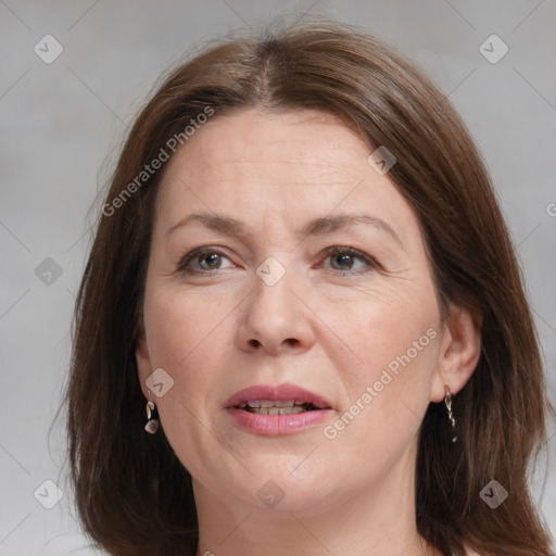 Joyful white adult female with medium  brown hair and grey eyes