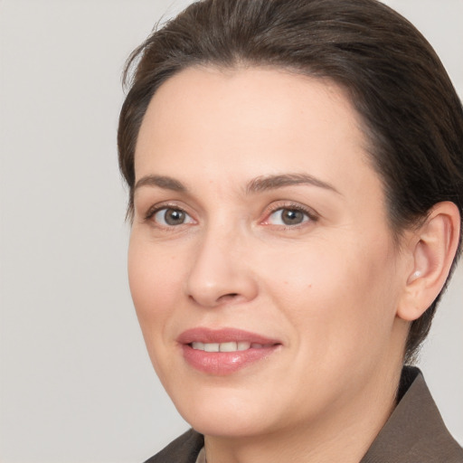 Joyful white adult female with medium  brown hair and brown eyes