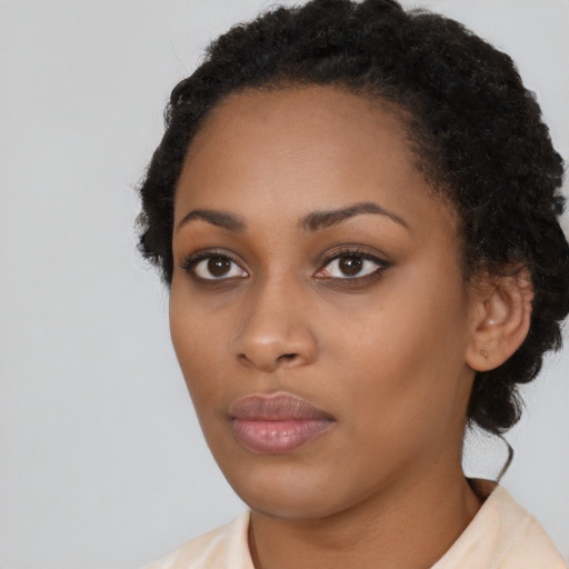 Neutral black young-adult female with short  brown hair and brown eyes