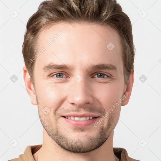 Joyful white young-adult male with short  brown hair and grey eyes