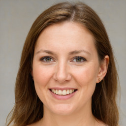 Joyful white adult female with medium  brown hair and blue eyes