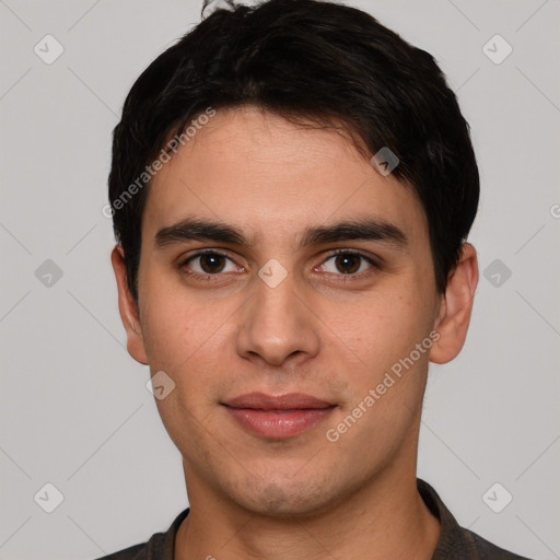 Joyful white young-adult male with short  black hair and brown eyes