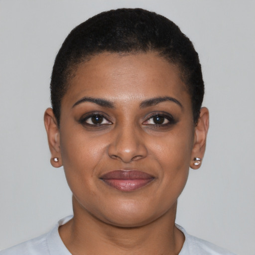 Joyful black young-adult female with short  brown hair and brown eyes