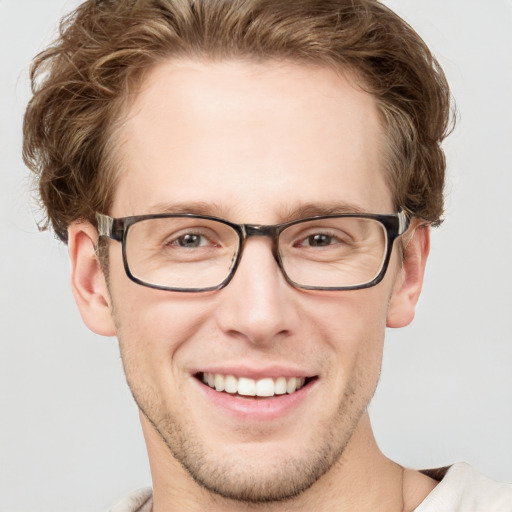 Joyful white adult male with short  brown hair and grey eyes