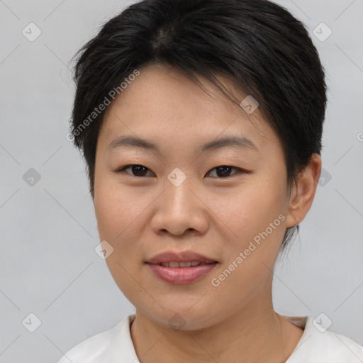 Joyful asian young-adult female with short  brown hair and brown eyes