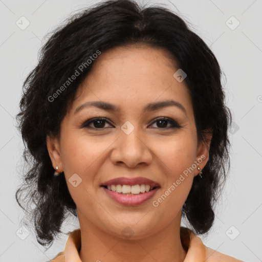 Joyful latino adult female with medium  brown hair and brown eyes