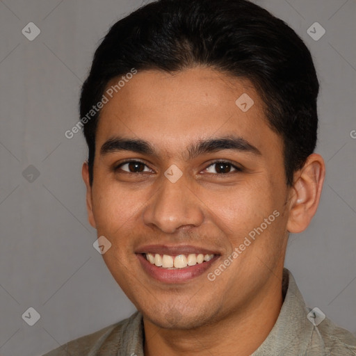 Joyful latino young-adult male with short  brown hair and brown eyes