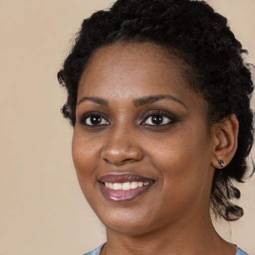 Joyful black young-adult female with medium  black hair and brown eyes