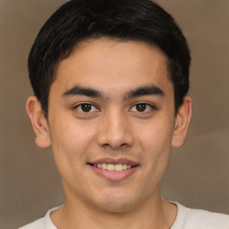 Joyful latino young-adult male with short  brown hair and brown eyes