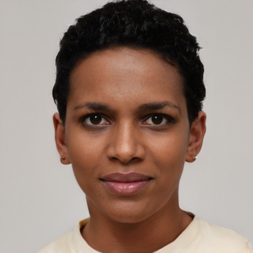 Joyful black young-adult female with short  black hair and brown eyes