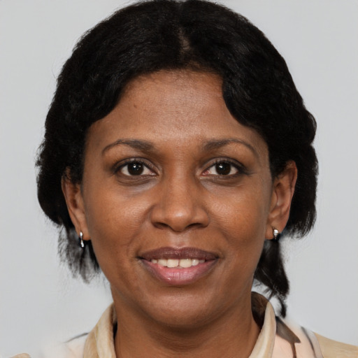 Joyful black adult female with short  brown hair and brown eyes