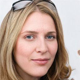 Joyful white young-adult female with long  brown hair and blue eyes