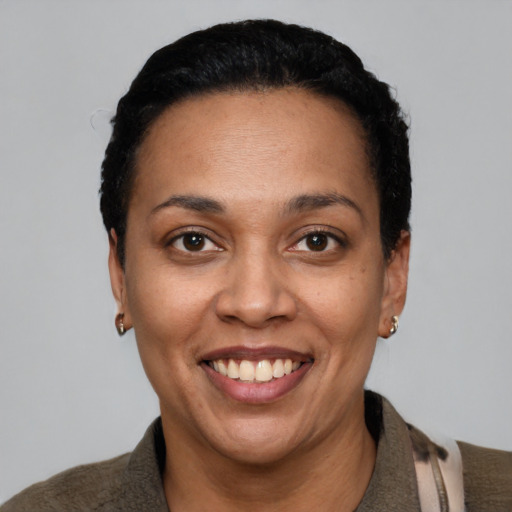 Joyful latino young-adult female with short  black hair and brown eyes
