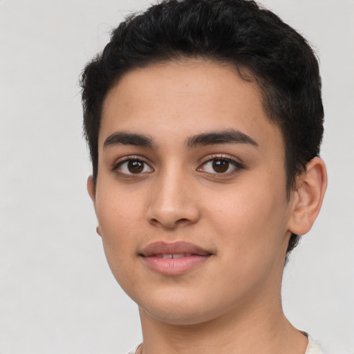 Joyful latino young-adult male with short  black hair and brown eyes